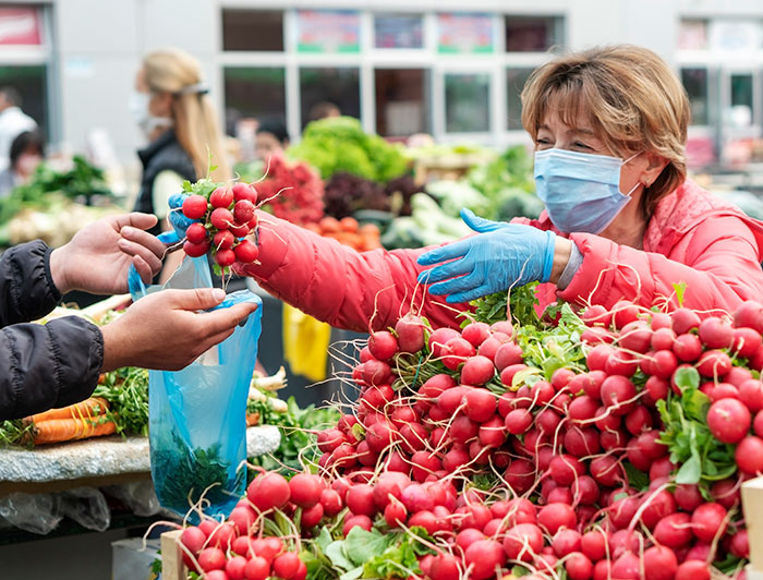 Handing over bought food in open food market 