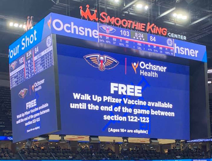 Stadium board advertises walk up vaccination clinic during a game
