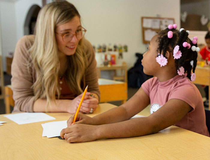 Working with a child at a table