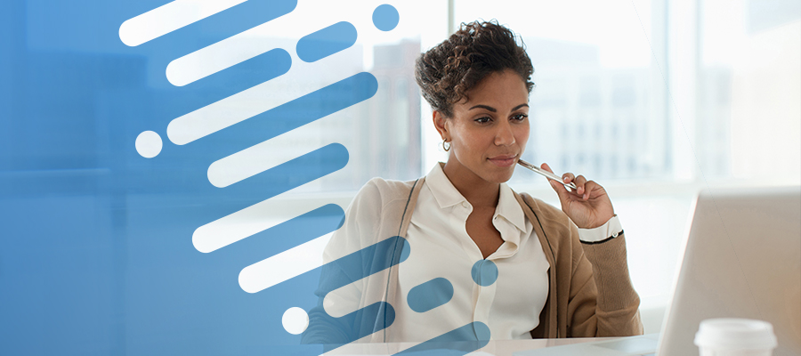 AHA Vitality Index. A black female hospital administrator looks at a computer screen and reviews health insurer claims and payment data.