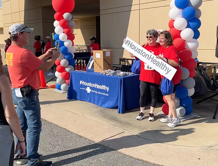 Dog and handler next to a blue bus