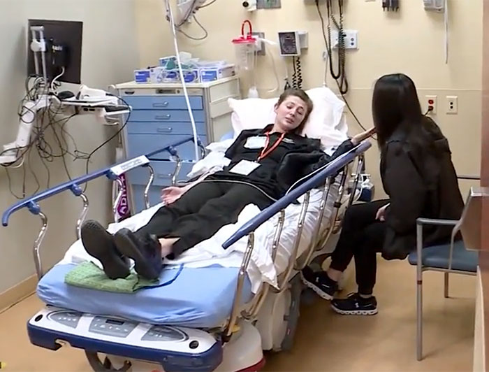 Colorado Springs. Drill -- young man in emergency room with family member at his bedside