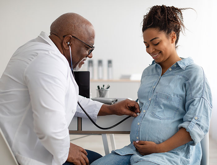Doctor monitoring pregnant mothers health of pregnancy