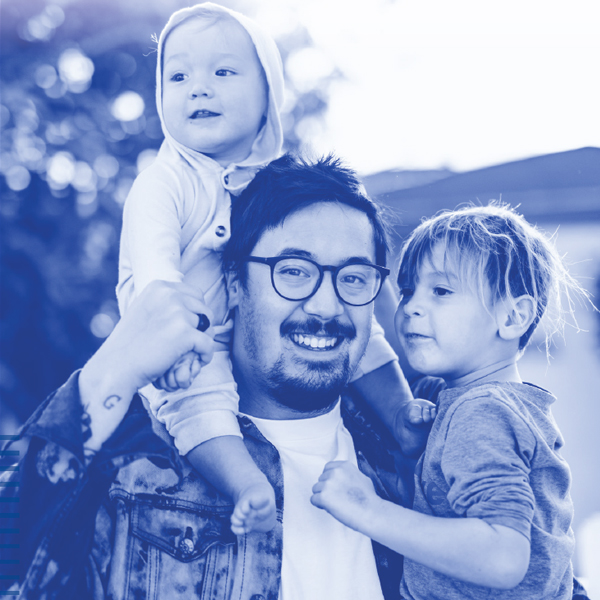 Father with one kid on shoulder and holding another