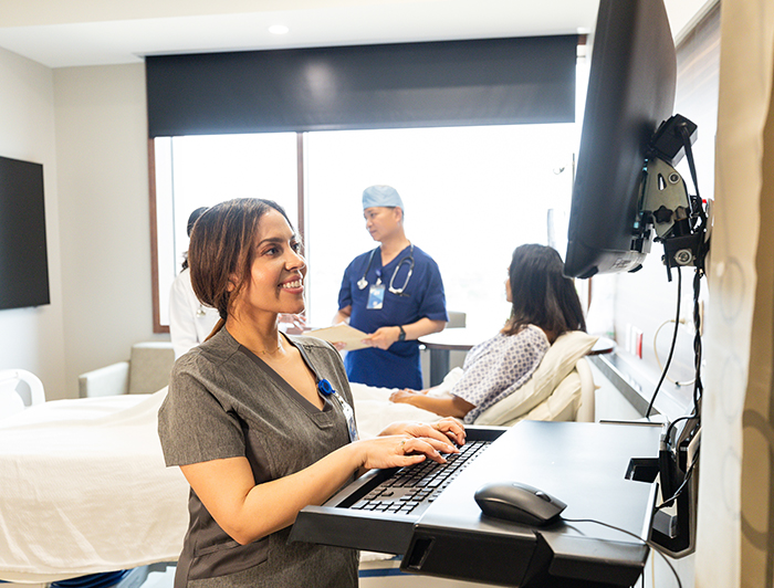 Overlake Medical Center and Clinics. Stock image of clinician using computer at bedside