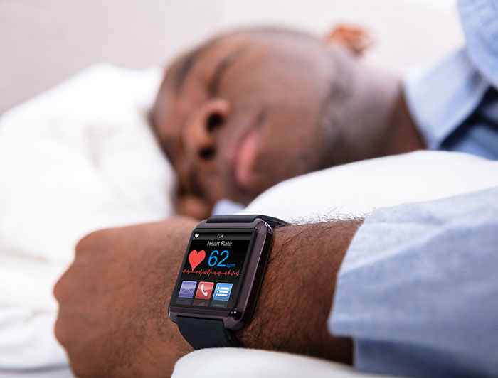 Los Alamos Medical Center. Stock image of a patient sleeping and wearing a smartwatch with heart monitor