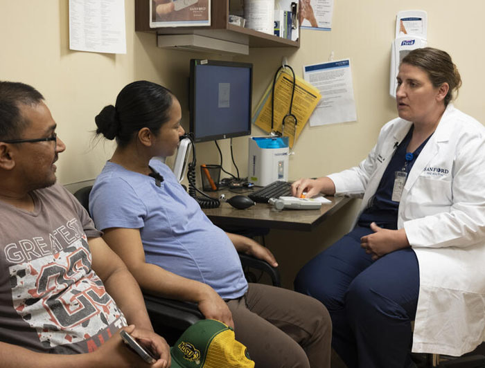 Sanford Health. Elizabeth Brown, Sanford Health physician, speaks with a patient in her office