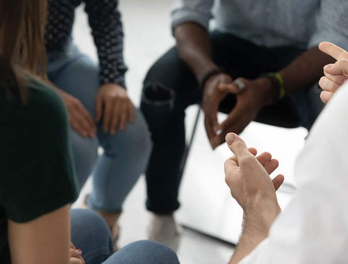 Stock image of people sitting together - close-up of hands