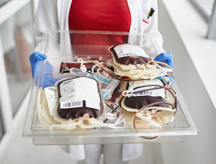 Cheyenne Regional Medical Center. Stock image of hospital worker holding a tray of IV blood bags