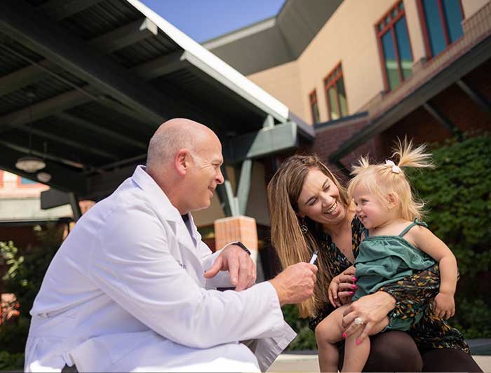 Medical personal making a little child happy