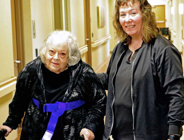 Tomah resident Jackie Flock, left, walked with assistance from Tomah Health certified nursing assistant / Ambulation Aide Vicki Gonzales. Hospital officials say the WHA designed MOVIN program has made a difference for patients and staff.