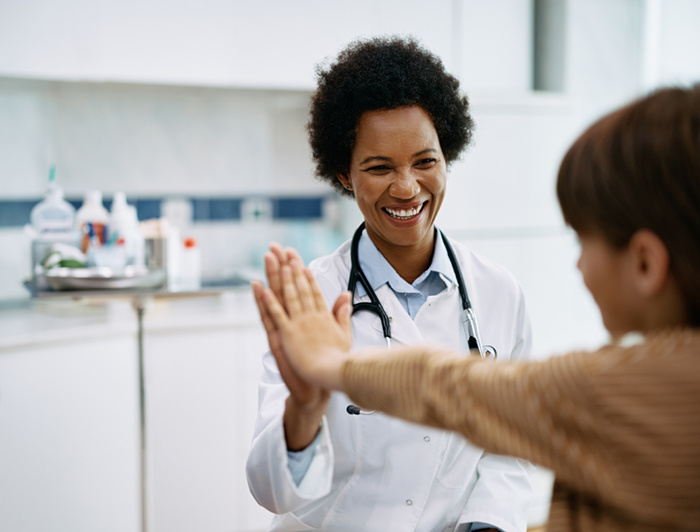 exas Children’s Hospital and UT MD Anderson Cancer Center join forces to end pediatric cancer. Female physician high-fives pediatric patient in an exam room.