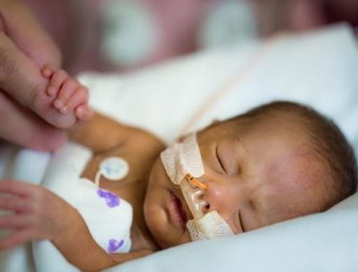 NICU baby holding a finger