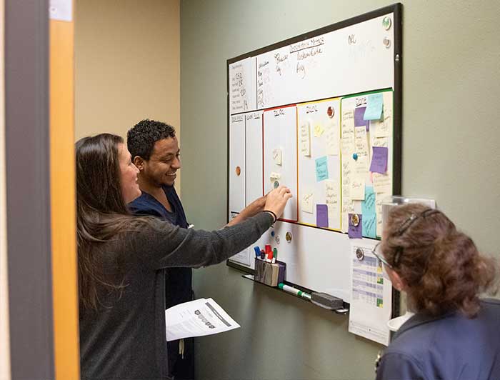 Columbia Memorial staff looking at a whiteboard