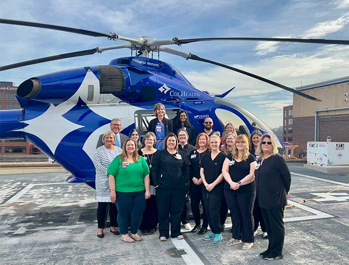  CoxHealth Trauma Services Team standing together infront of a CoxHealth chopper