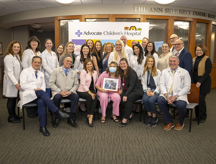 Advocate Children's transplant patient Nataly Paramo sits smiling in a group photo with the Advocate transplant team
