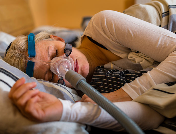 Alice Peck Day Memorial Hospital. A woman sleeps while wearing a breathing device