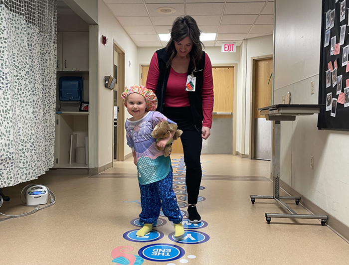 An Essentia Health-Fargo patient walks the sensory path with the help of a caregiver