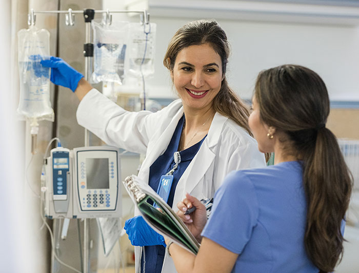 Jefferson Health program aims to fast-track Philly high school students into in-demand, entry-level health care jobs. Female health worker instructs young female trainee on using IV bags