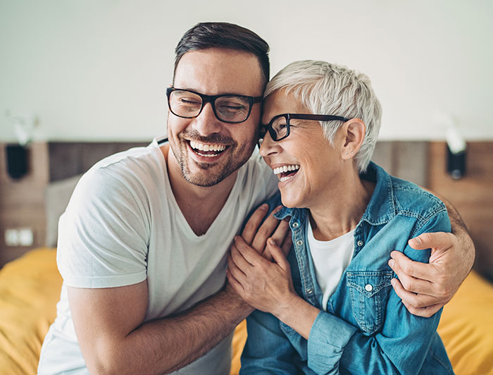Telling the Hospital Story: Dartmouth Health Online community offers lifeline for those facing illness and loss. Stock image of a man and woman laughing together