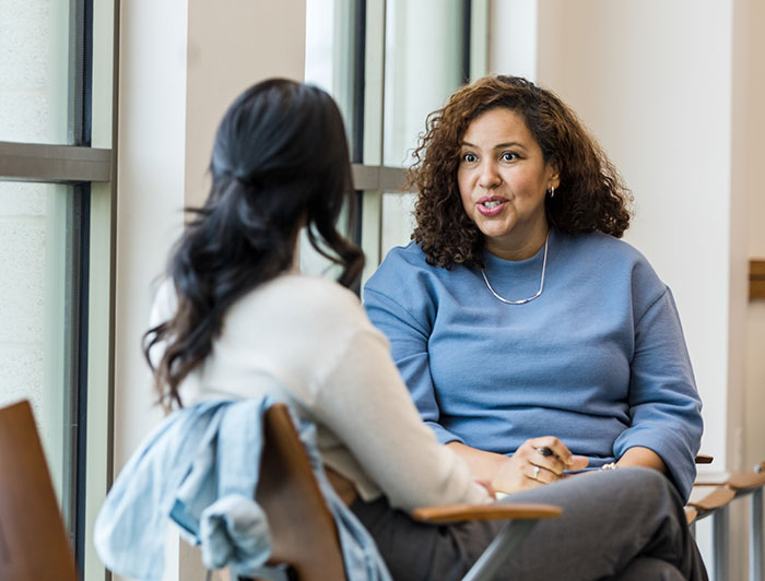 Telling the Hospital Story: Rochester Regional Health Healthy Moms program provides parents with multifaceted supports. A female health worker checks a pregnant woman's belly