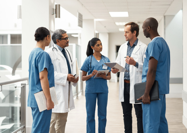 Group of medical staff in hall looking at tablet