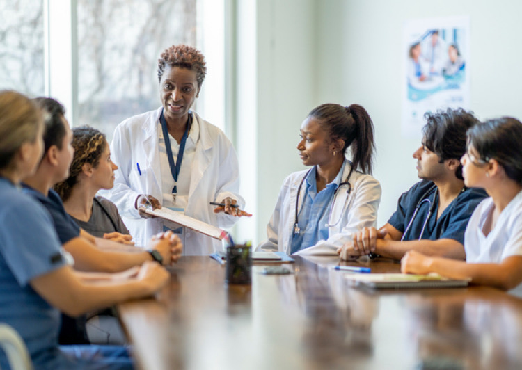Medical staff talking around a conference table