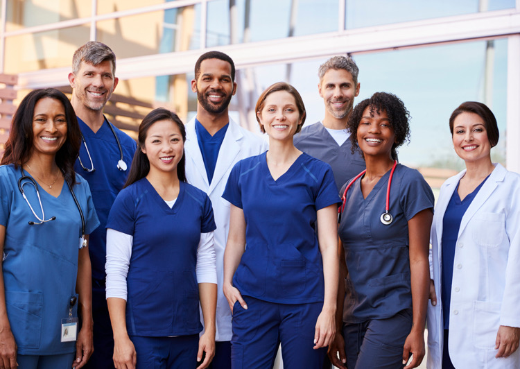 Multiple medical staff standing together for an image all smiling