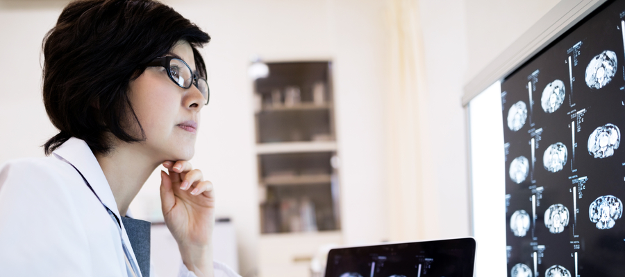 A female doctor looks at x-rays. 
