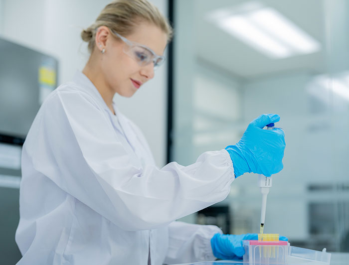 Telling the Hospital Story: Fred Hutchinson Cancer Center foam breakthrough boosts gene therapy; stock image of woman doing medical research in a lab