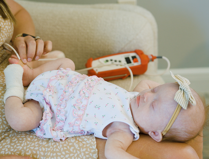 Newborn baby being examined at home; Telling the Hospital Story: Nemours Children’s Health redefines pediatric care with at-home model