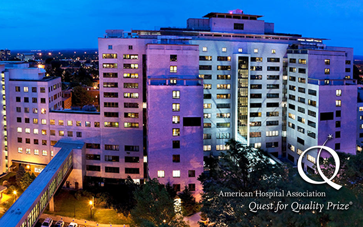 2025 AHA Quest for Quality Winner | Hartford HealthCare. American Hospital Association Quest for Quality Prize. Hartford HealthCare hospital lit up at night.