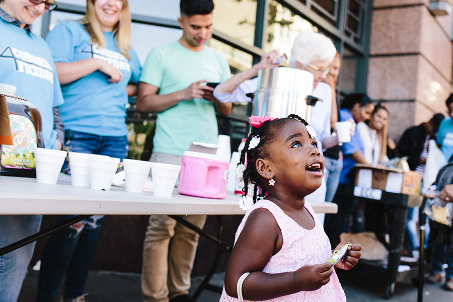 toddler looking up as workers look on