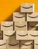 Amazon’s 3 Health Care Priorities. Amazon boxes stacked up.
