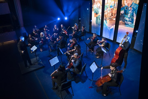 The AdventHealth Orchestra playing on stage.