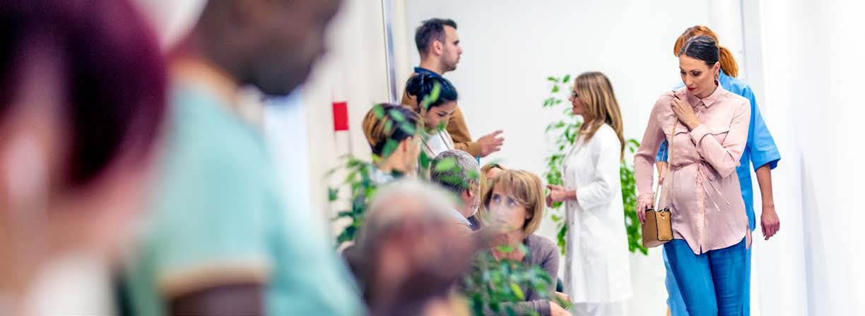 Community Benefit Report 2025. Clinicians talk to patients in a community hospital.