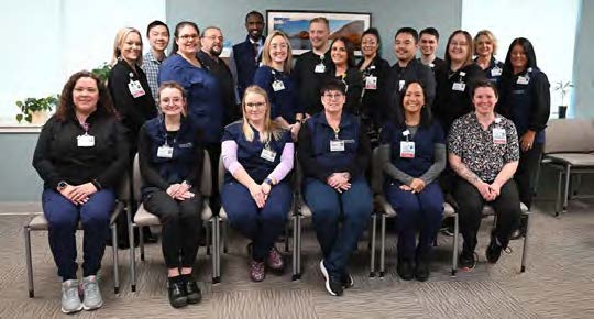 MaineGeneral staff seated and standing in a hospital conference room.