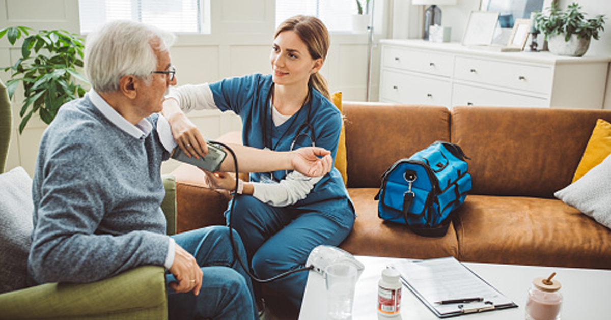 Providence and Compassus Partner to Launch Home Health Care Joint Venture. A home-health nurse takes an elderly man's blood pressure in his home.