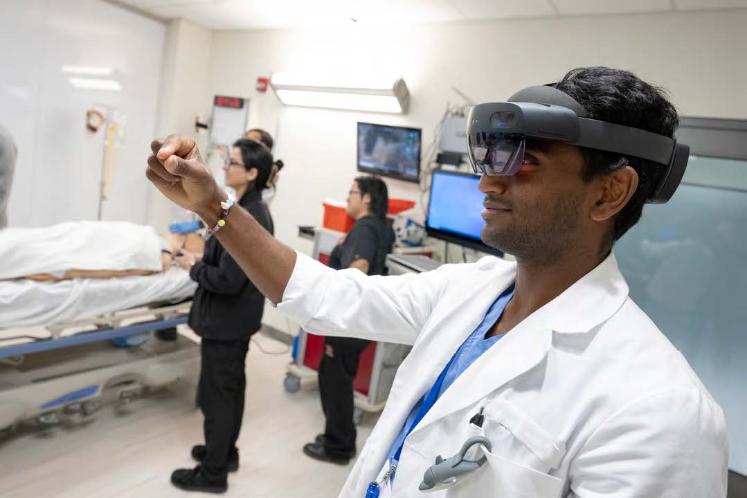 A clinician wearing virtual googles works at the RWJBarnabas Health and Rutgers Health Artificial Center of Excellence.