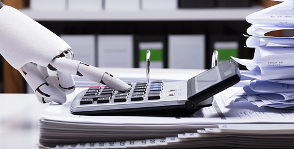 Revolutionizing Revenue-Cycle Management Efficiency with AI. A robotic hand types on a digital adding machine.