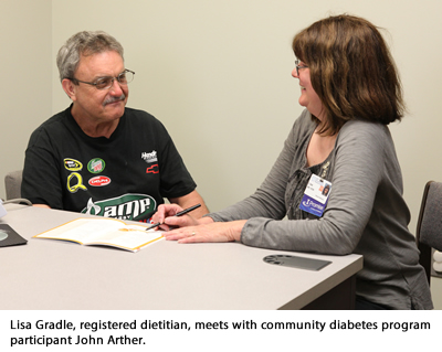 Lisa Gradle meets with program participant John Arther