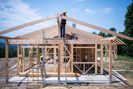 Study: Housing for Health Program Generates Significant Social Value and ROI. A construction crew frames a house.
