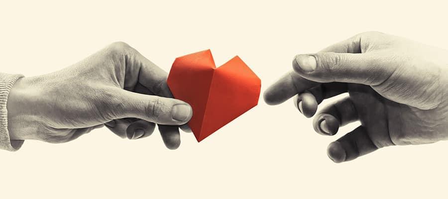 handing off a paper heart