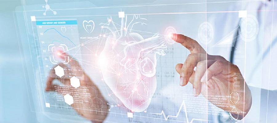 A doctor examines a heart that is projected onto a transparent screen.
