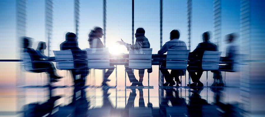 Action blur shot of board meeting at sunset