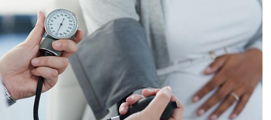 female patient is checked for hypertension with cuff