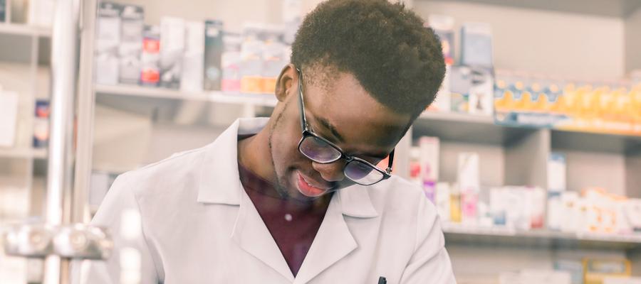 Pharmacist writes note at counter