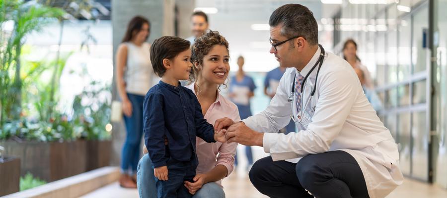 A young boy and his mother talk to a doctor 