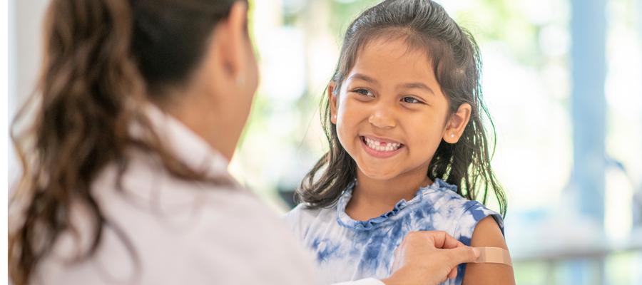 Smiling young girl gets a shot