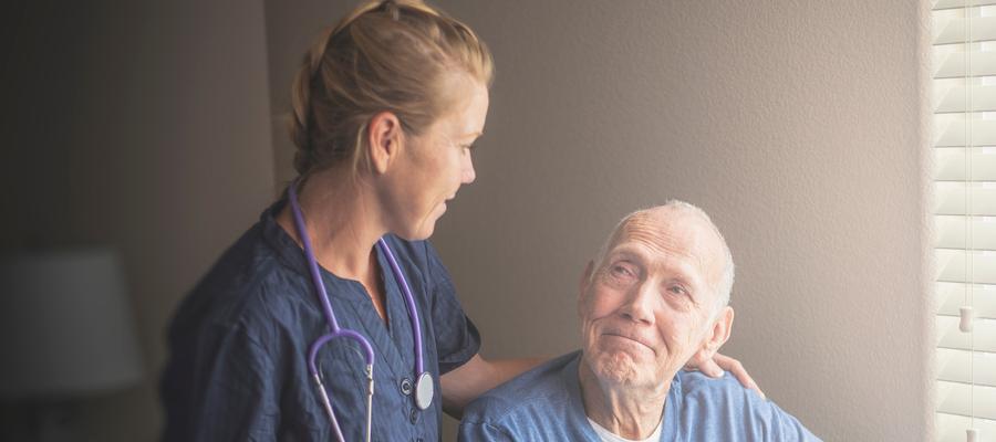 Female provider looking at older man